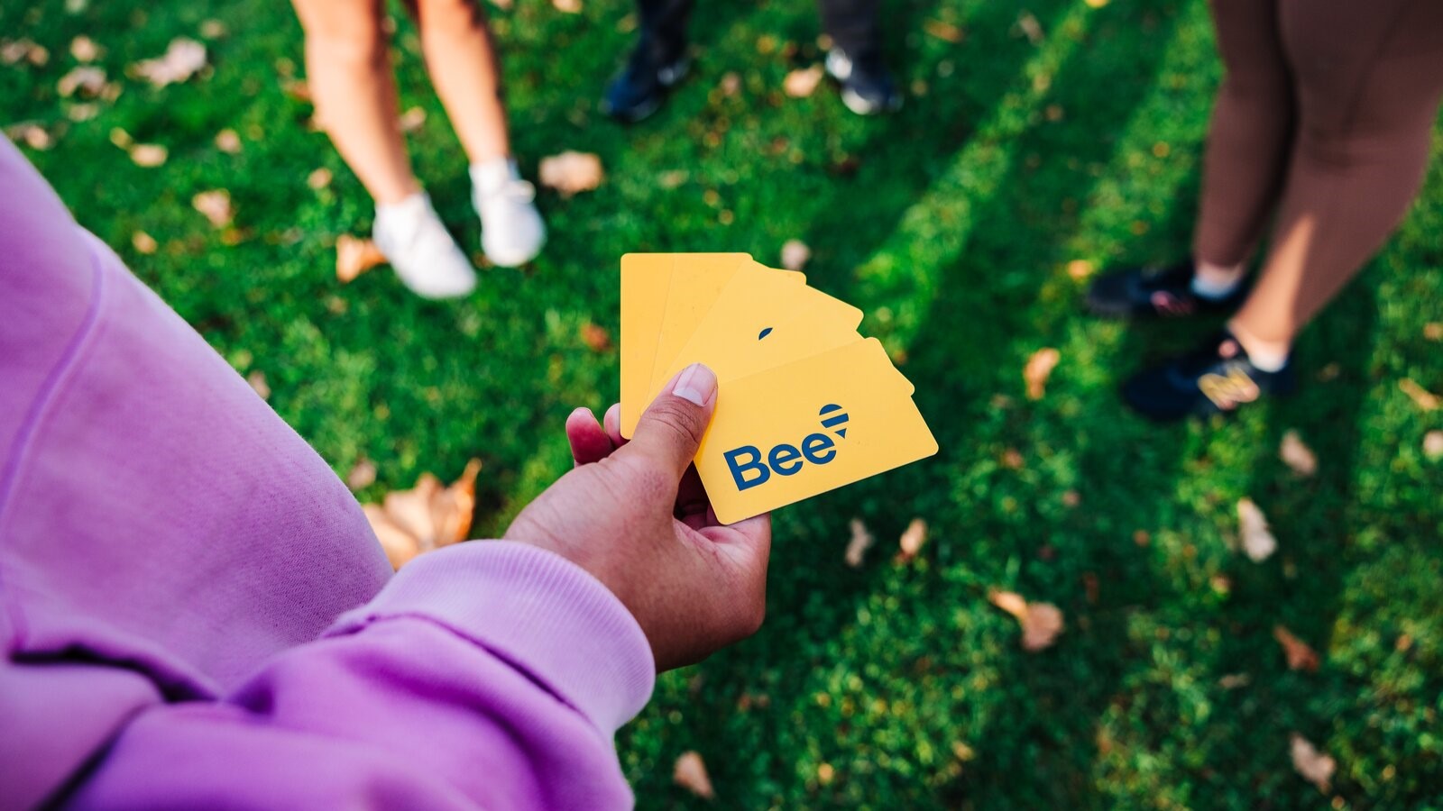 Bee cards held by person in community