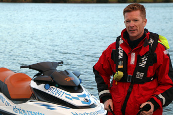 Waikato Regional Harbourmaster Chris Bredenbeck in front of the harbourmaster jetski