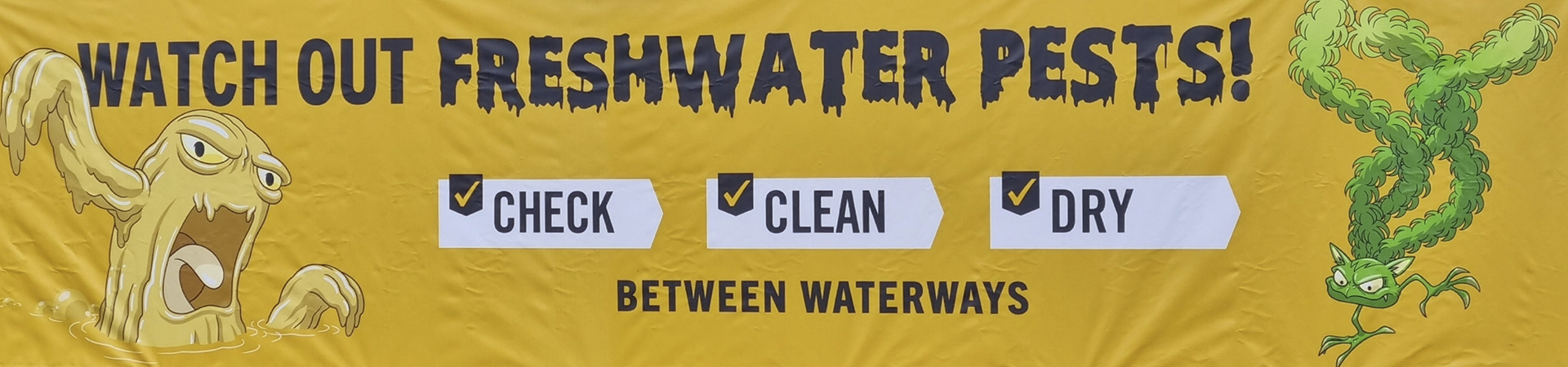 Yellow banner with pest 'monsters' telling people to check, clean and dry between waterways