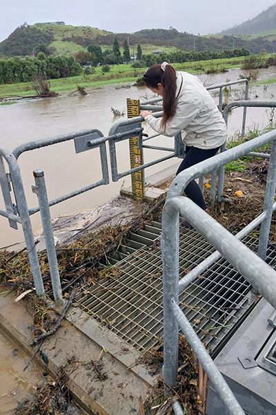 Council staff measuring debris at the floodgate