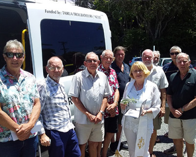 Image of several people standing in front of a van