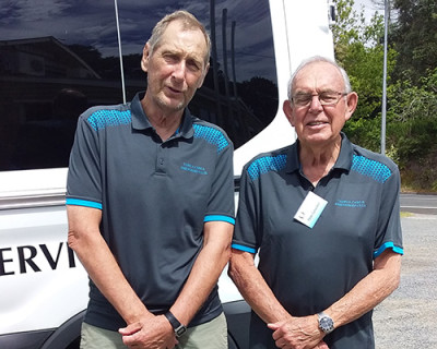 Image of two men standing next to a van