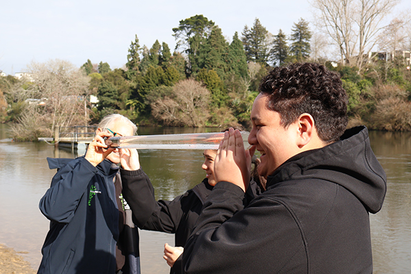 Students partaking in a water quality test