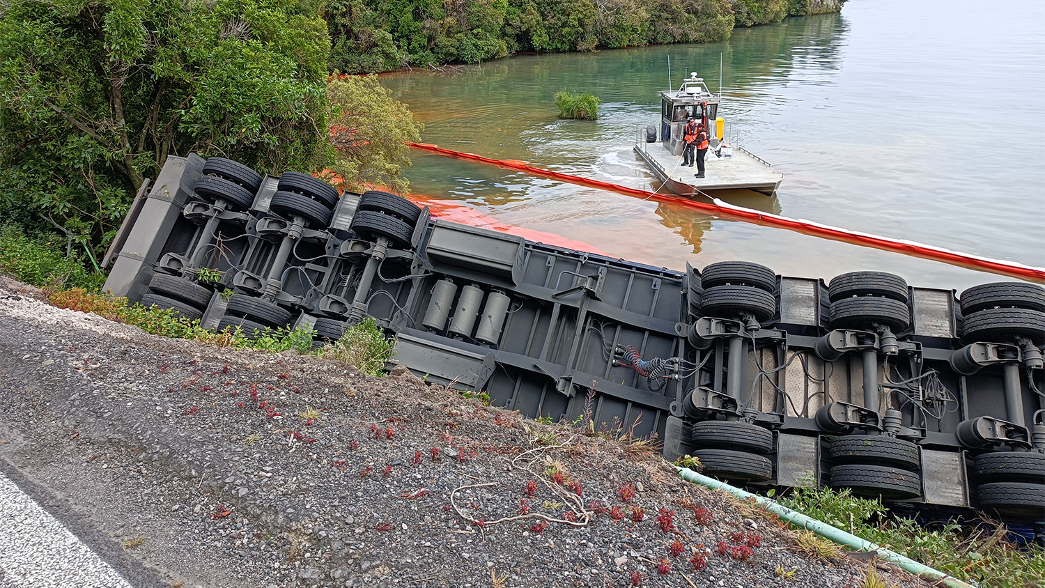 Truck rollover with inflatable booms in view and Te Pōporo | Bulli Point in the distance (south)